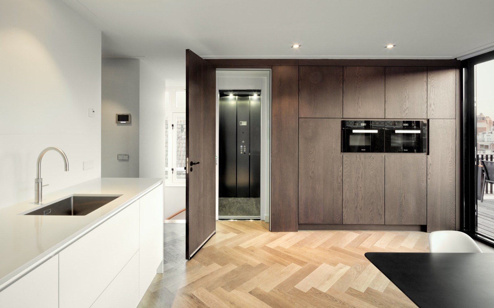 Walnut veneer built-in cabinetry with integrated appliances