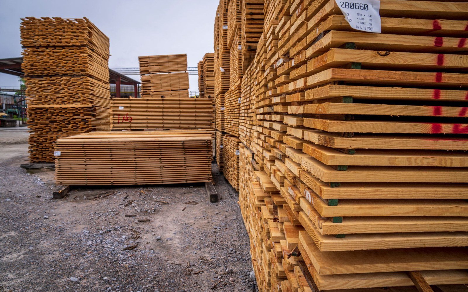 Stacks of sawn timber boards at an outdoor lumber yard