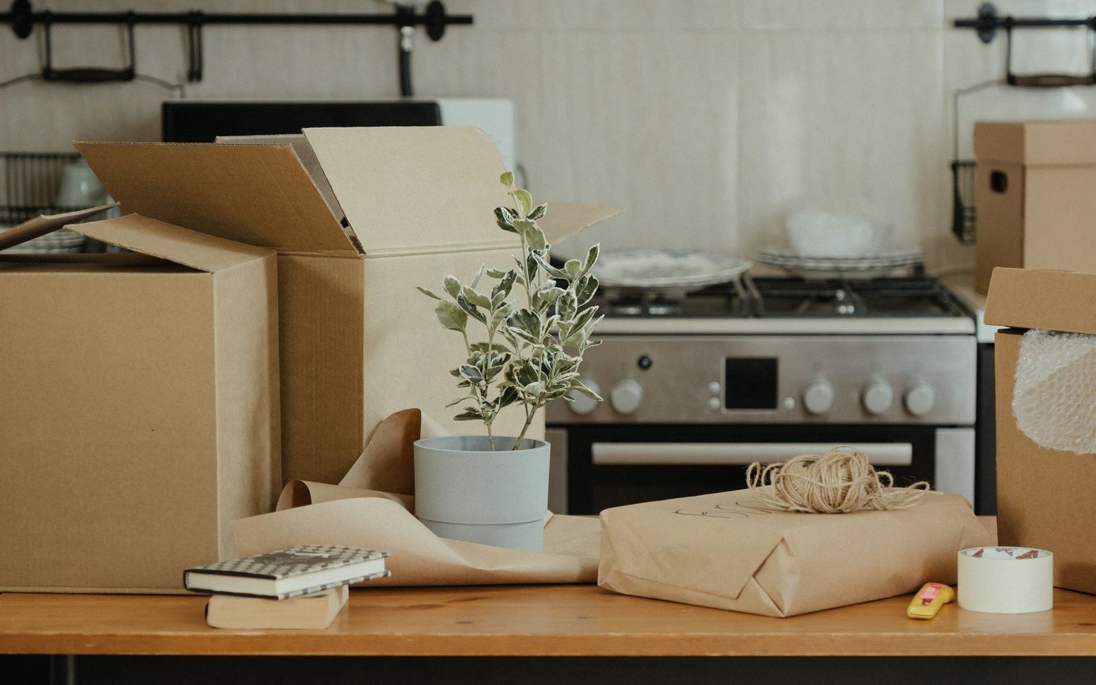 Open moving boxes on a kitchen counter in a new home