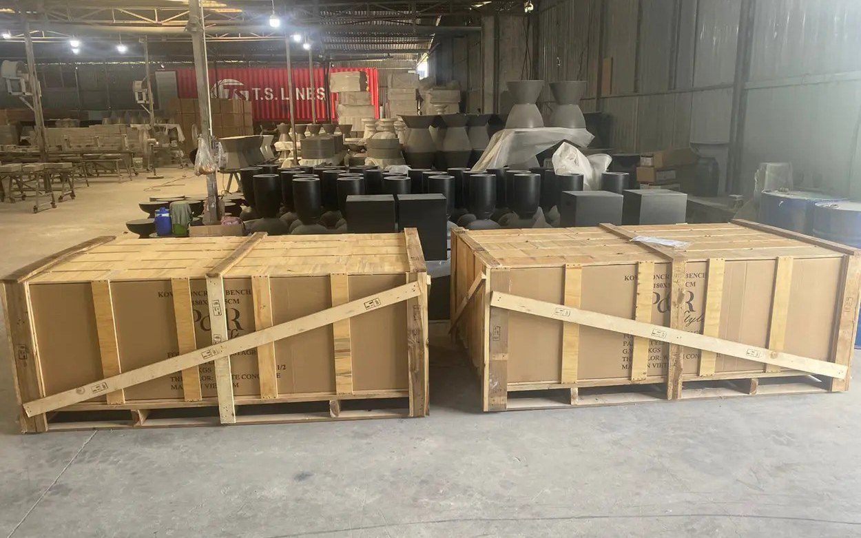 Numbered furniture crates staged in the packing hall, ready for container loading