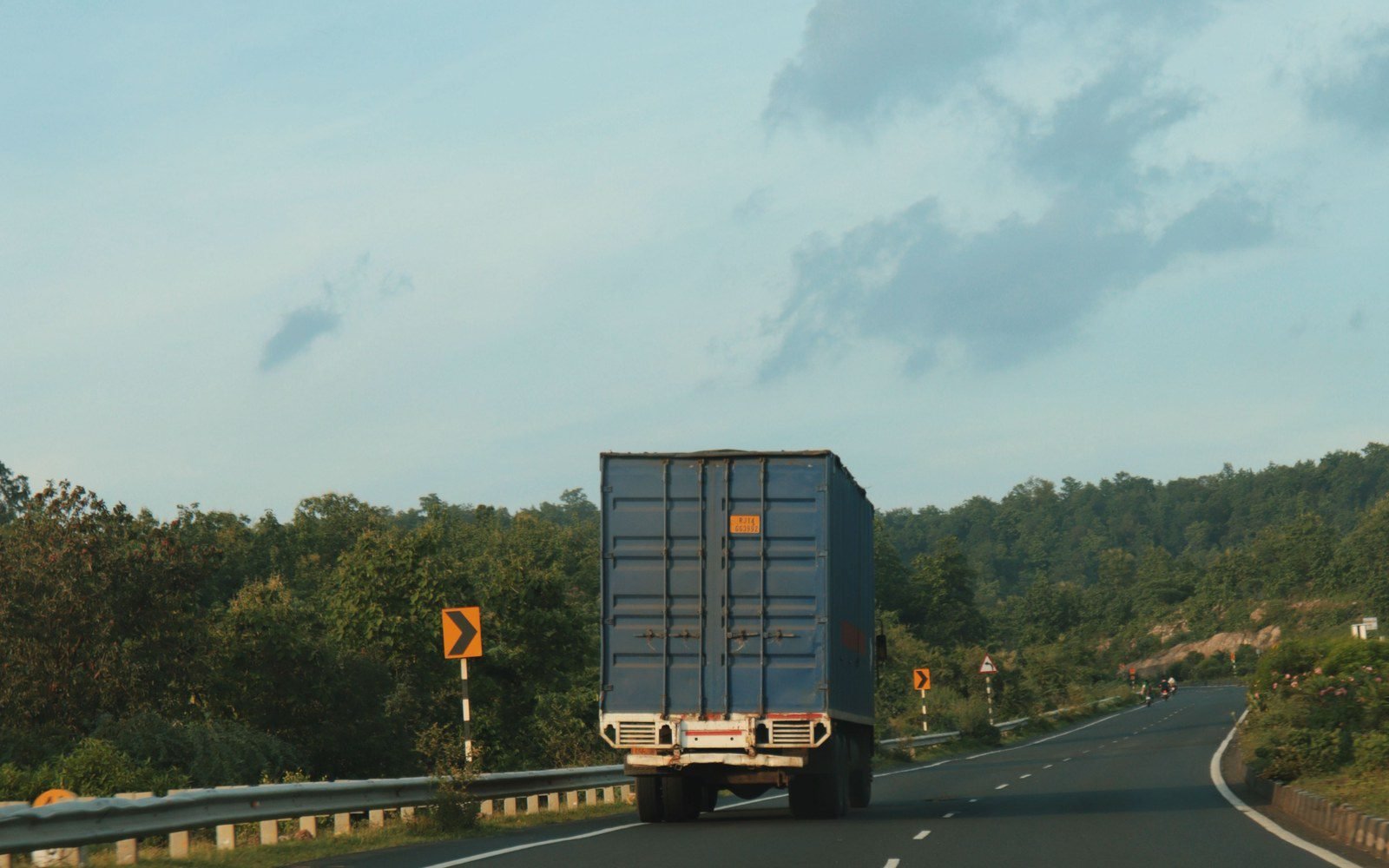 A sealed shipping container in transit to the port by road