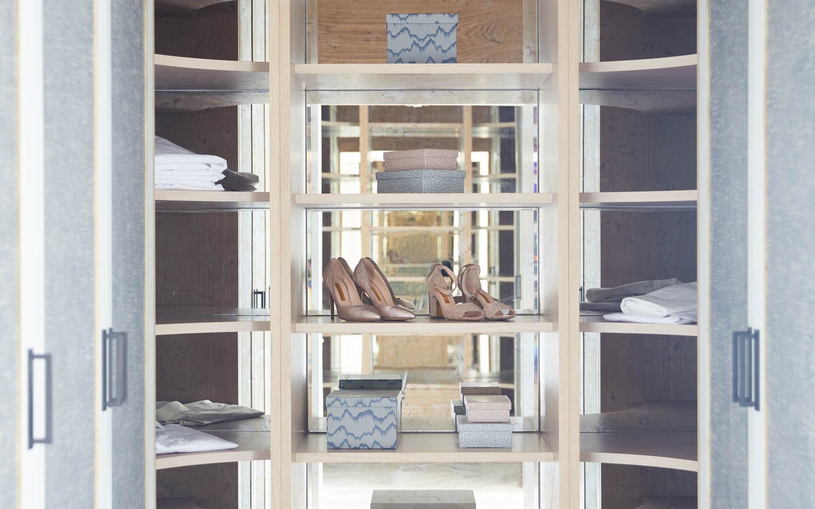 Light oak walk-in wardrobe with glass shelving and a mirrored centre section, made to measure