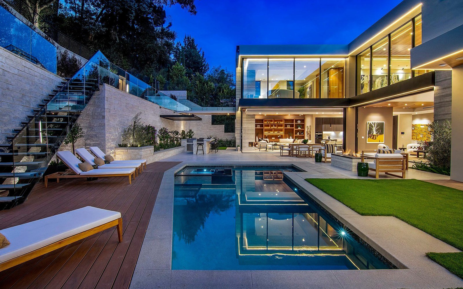 Completed modern villa with pool and large-format glass at dusk