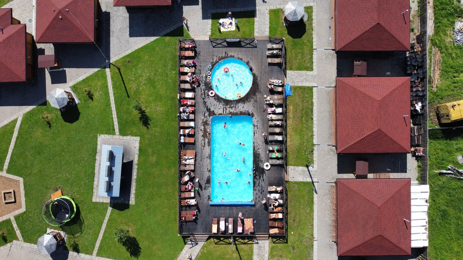 aerial view of a villa pool with stone deck and lawn