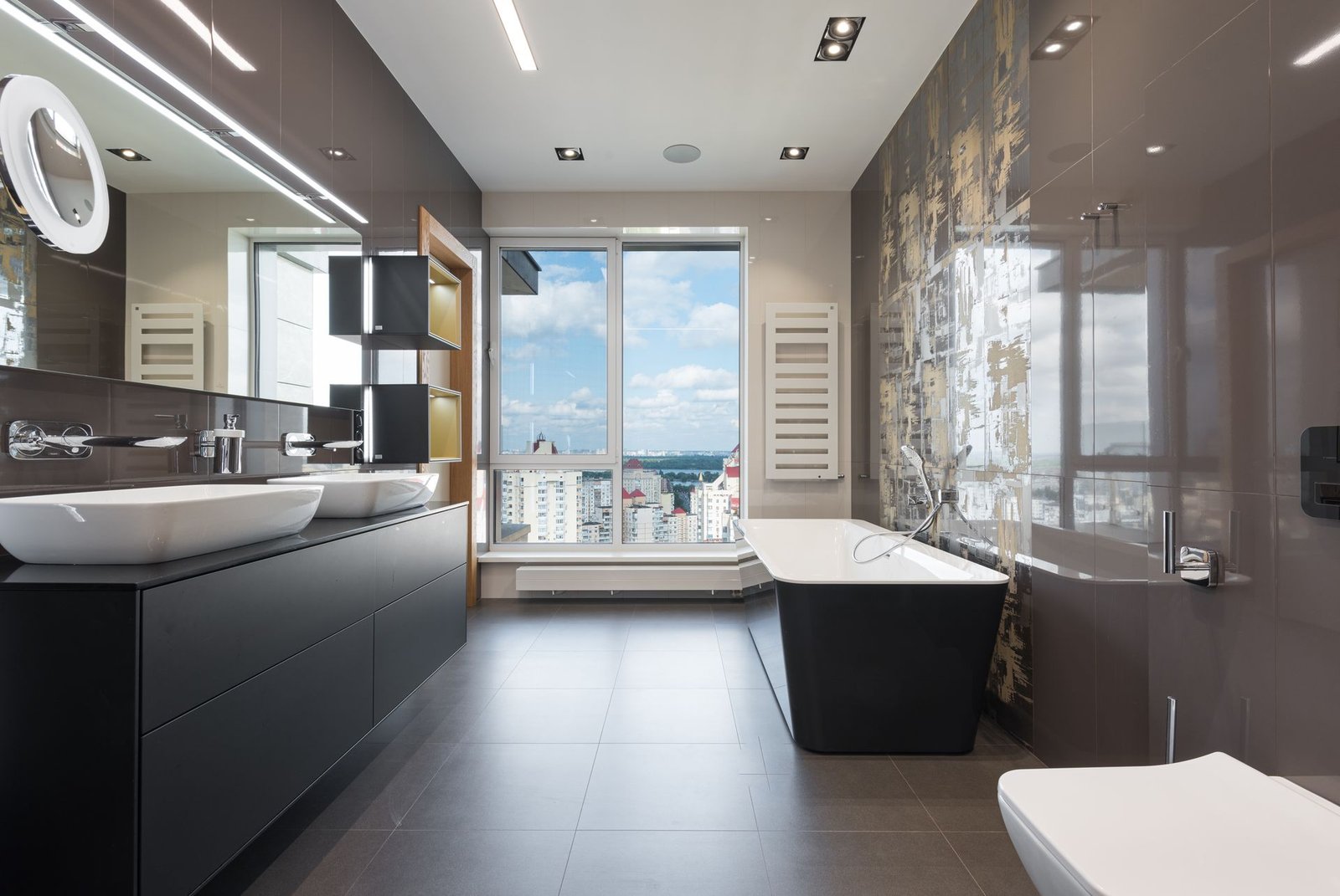 dark grey sintered stone slab wall in a villa bathroom with city view