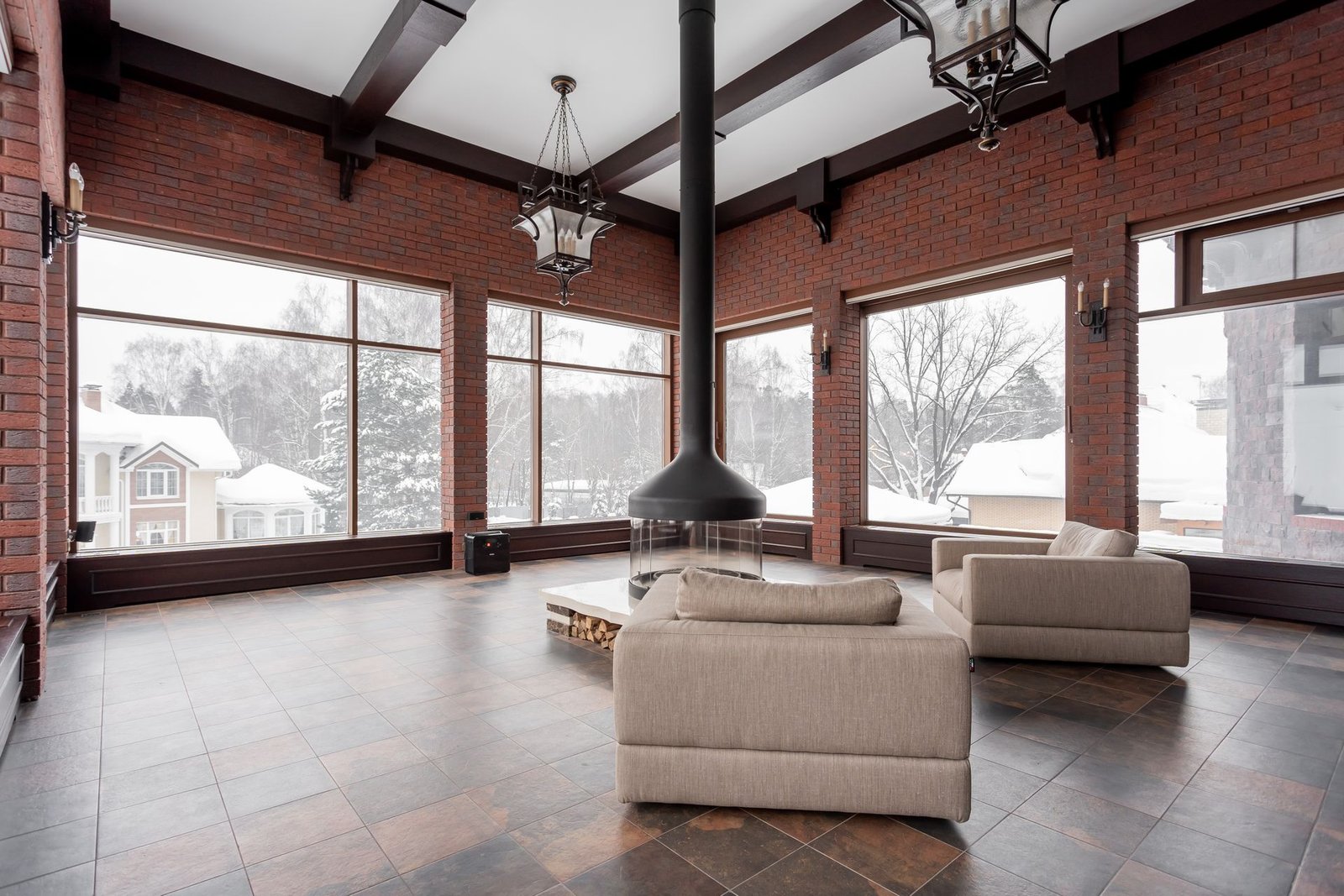 large-format terracotta-look tile floor in a brick villa living room