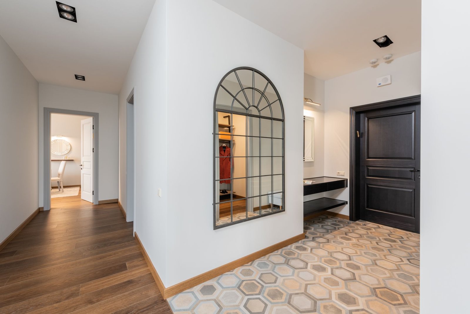 SPC wood floor meeting hexagonal tile in a villa hallway