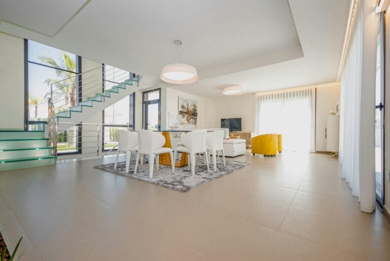 Bright modern villa interior with glass staircase and floor-to-ceiling windows - coordinated custom interiors