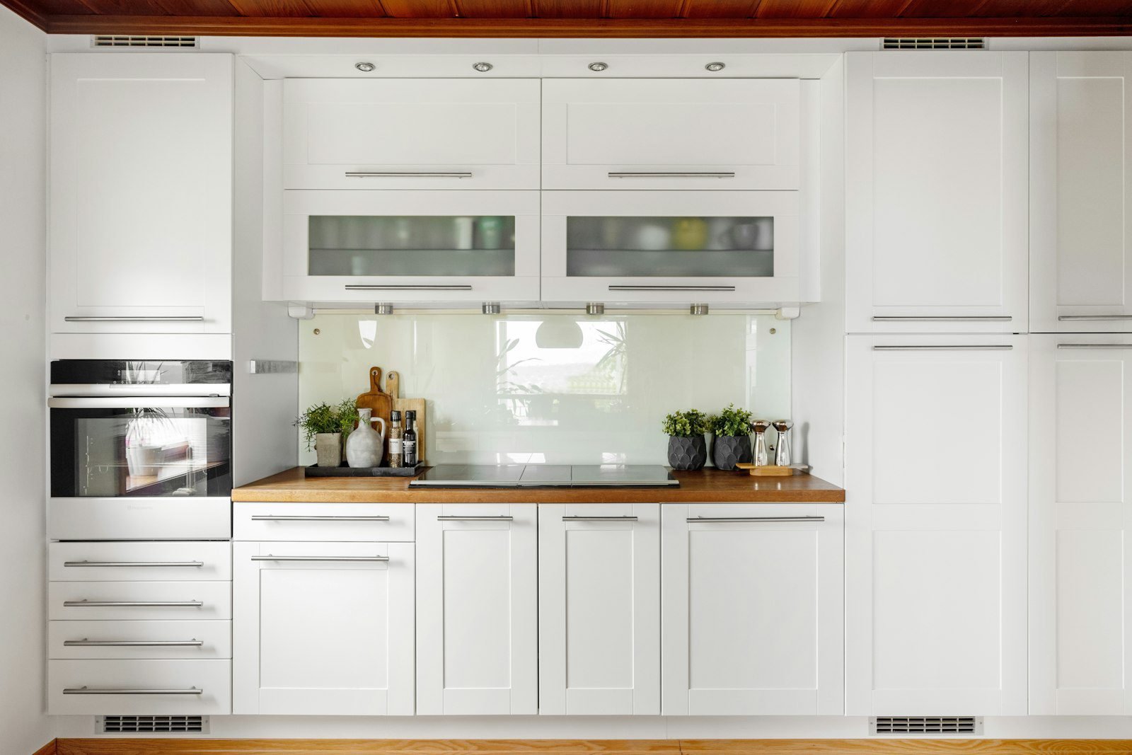 White glass-door kitchen with integrated appliances