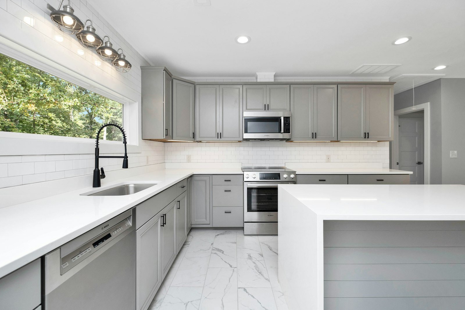 Bright island kitchen with integrated appliances