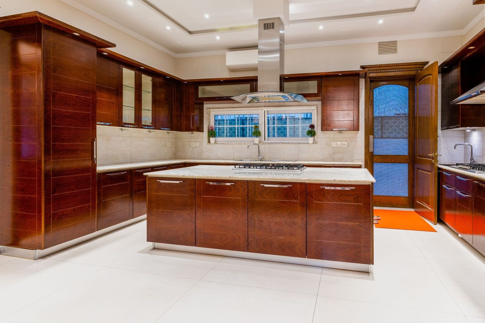 Dark walnut kitchen with island and warm under-cabinet lighting