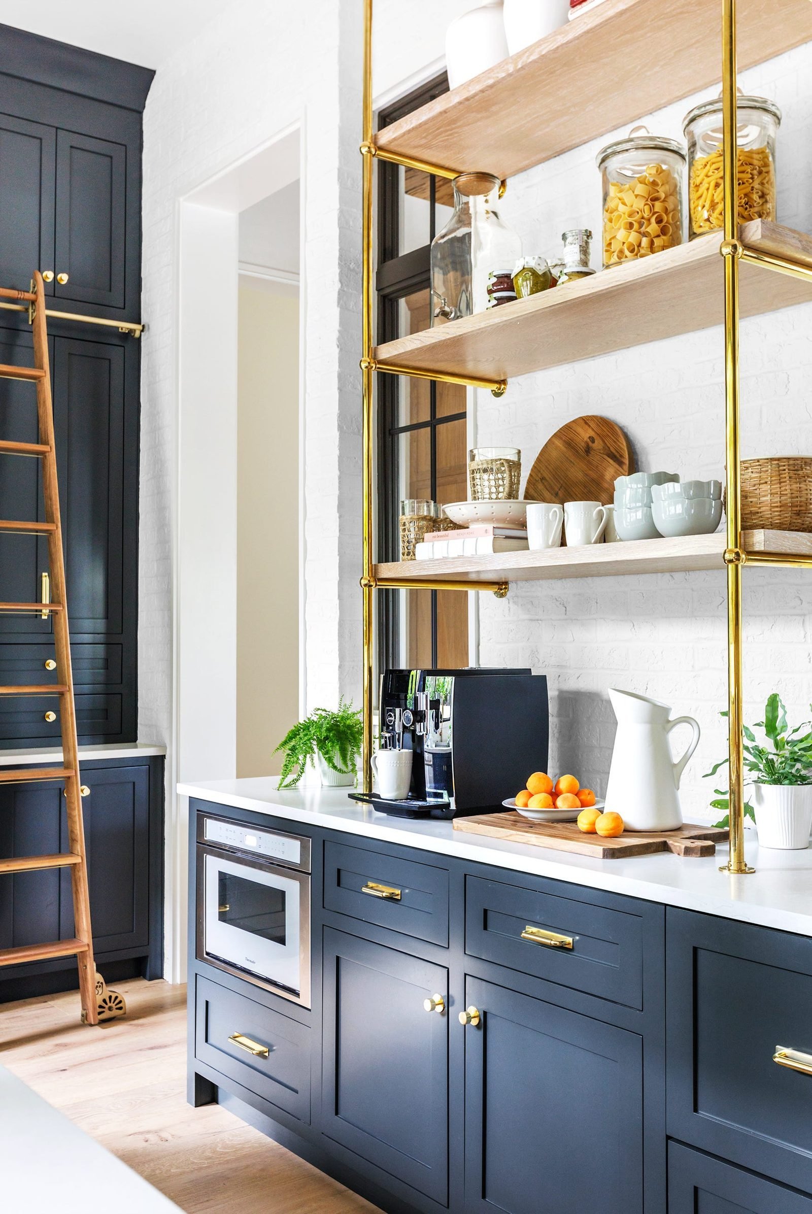 Navy butler's pantry with brass fittings and open shelving