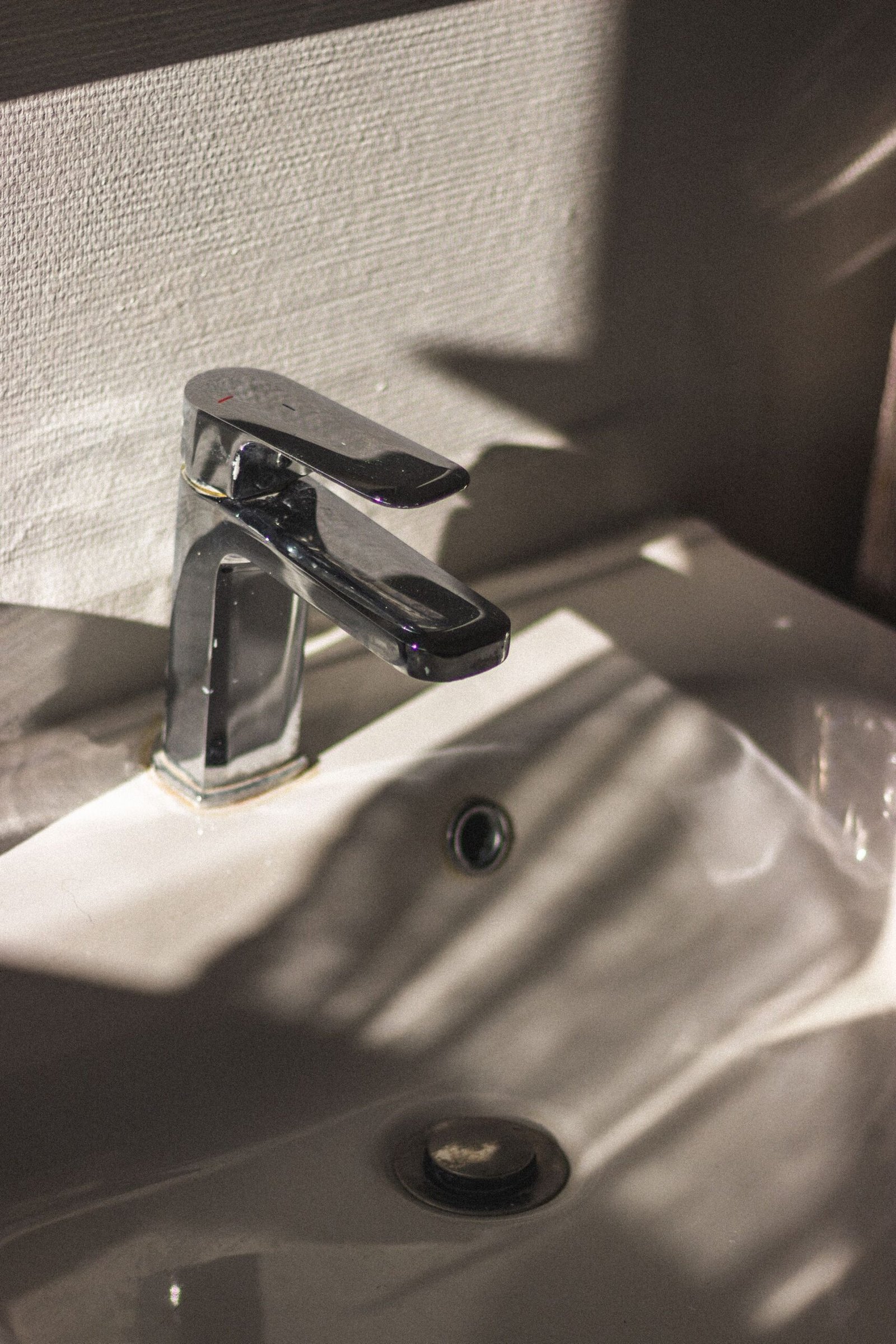 Chrome basin tap in natural light