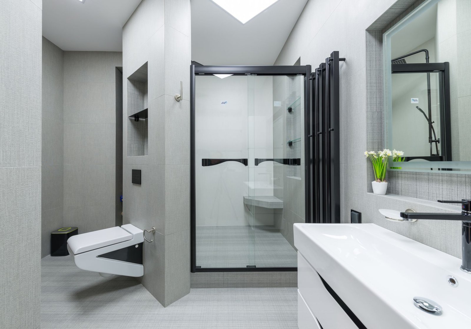 Wall-hung toilet with floating vanity and glass screen