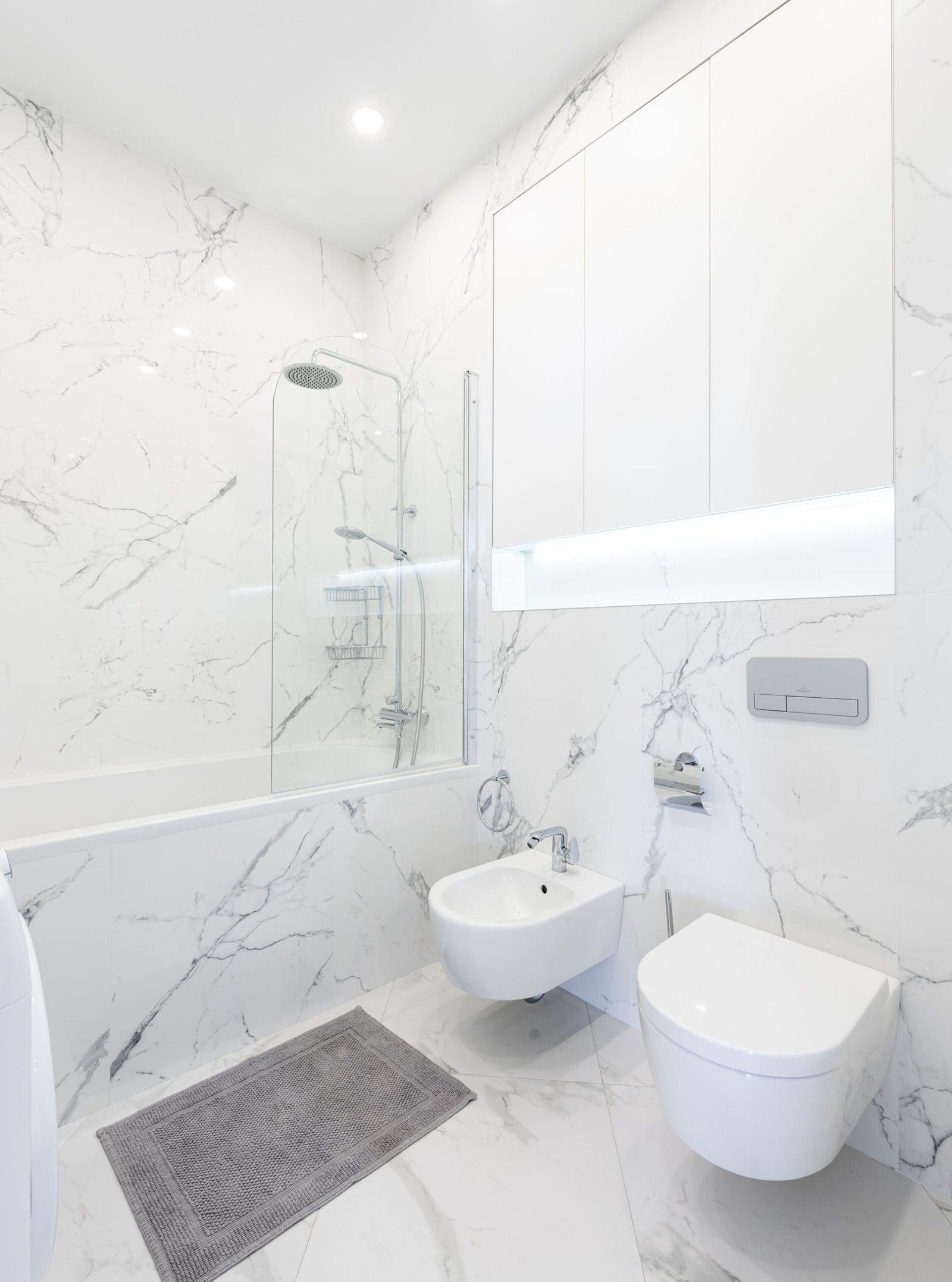 White marble wet area with wall-hung toilet and bidet