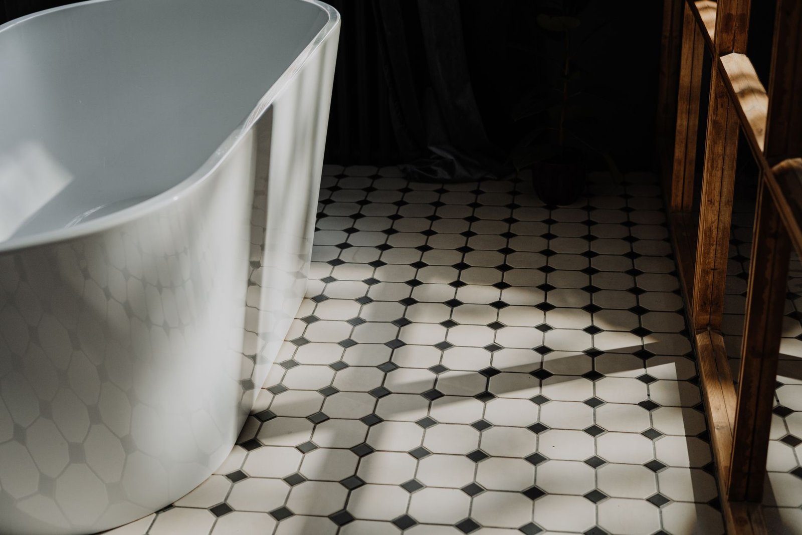 Marble-look freestanding tub over a hex tile floor