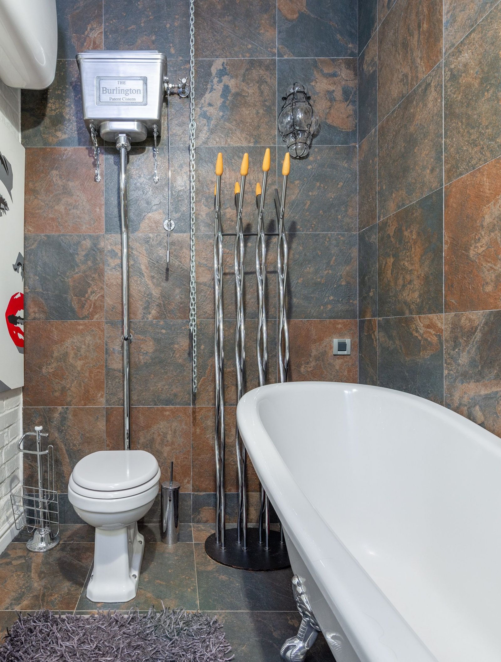 Freestanding tub in a terracotta-tile bathroom