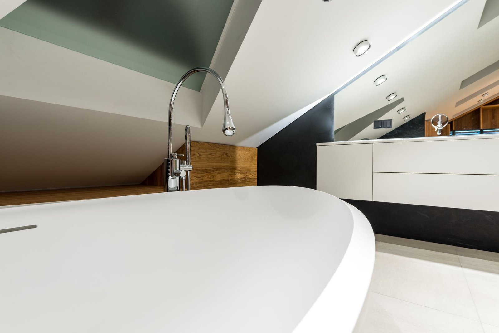 Freestanding tub under a pitched ceiling