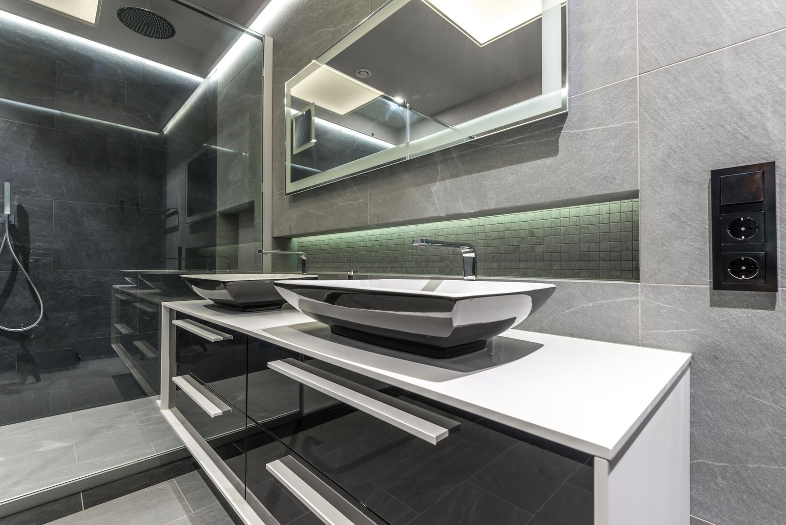 Grey-tile master bath with double vessel basins and LED mirror
