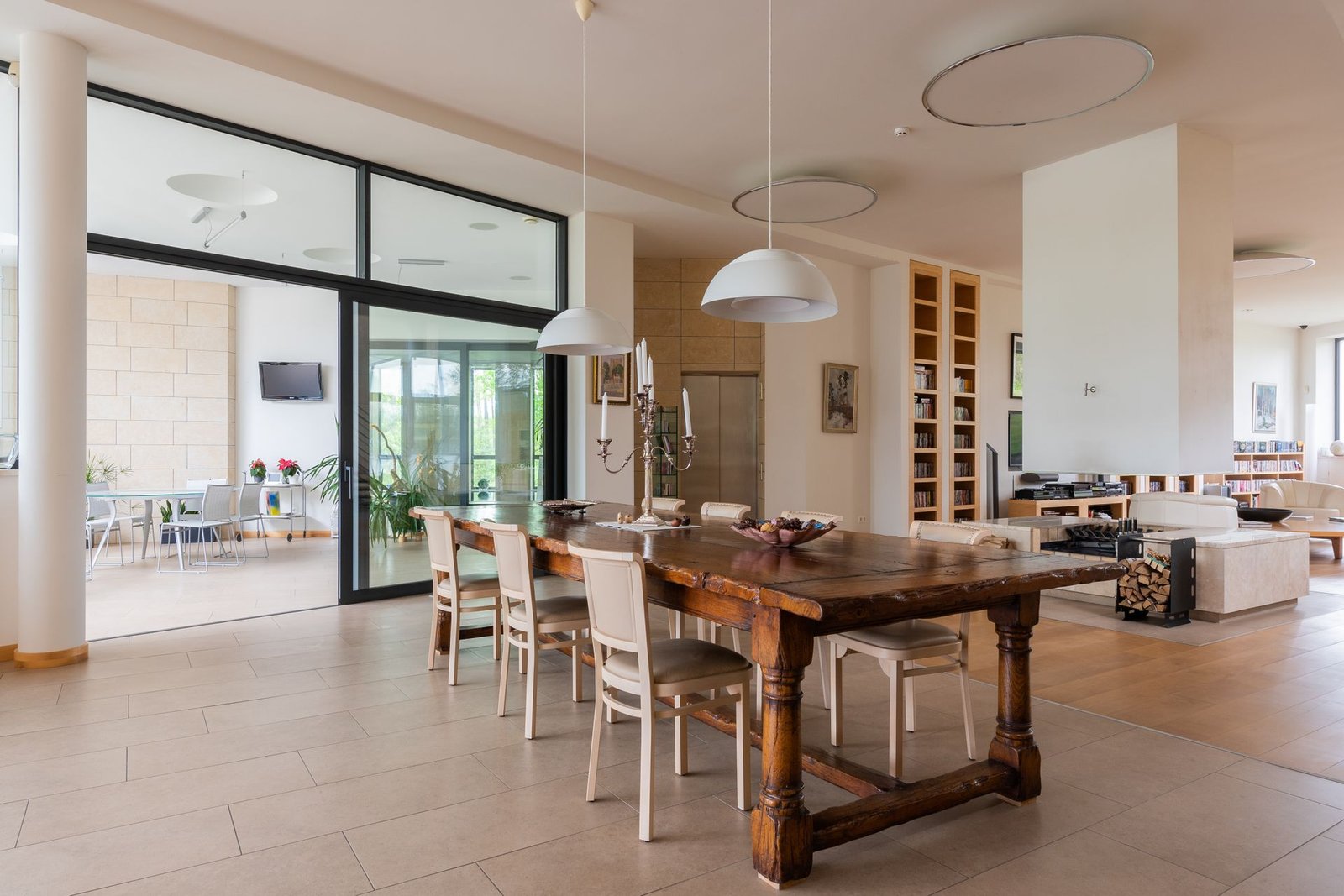Long solid wood dining table with upholstered chairs