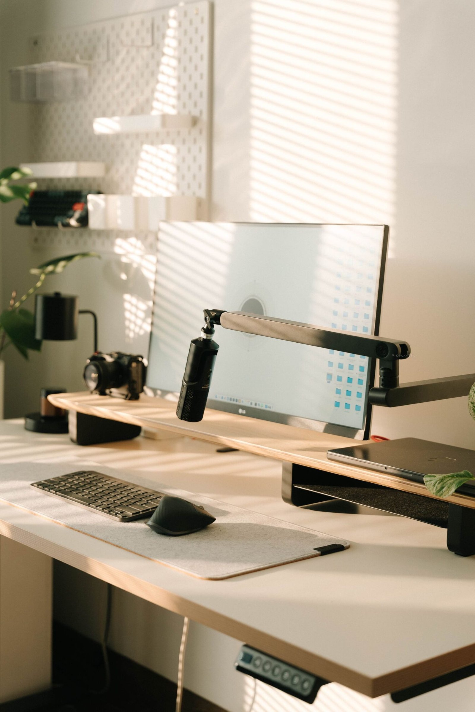 Light study desk with monitor and plants