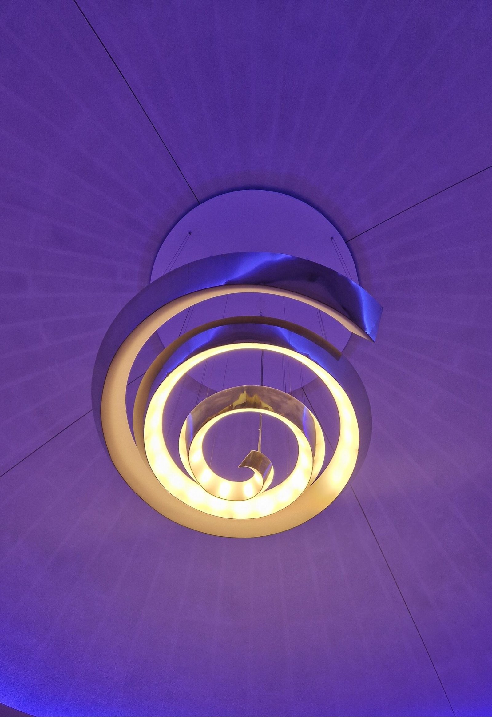 Spiral ring ceiling light with a coloured accent ceiling