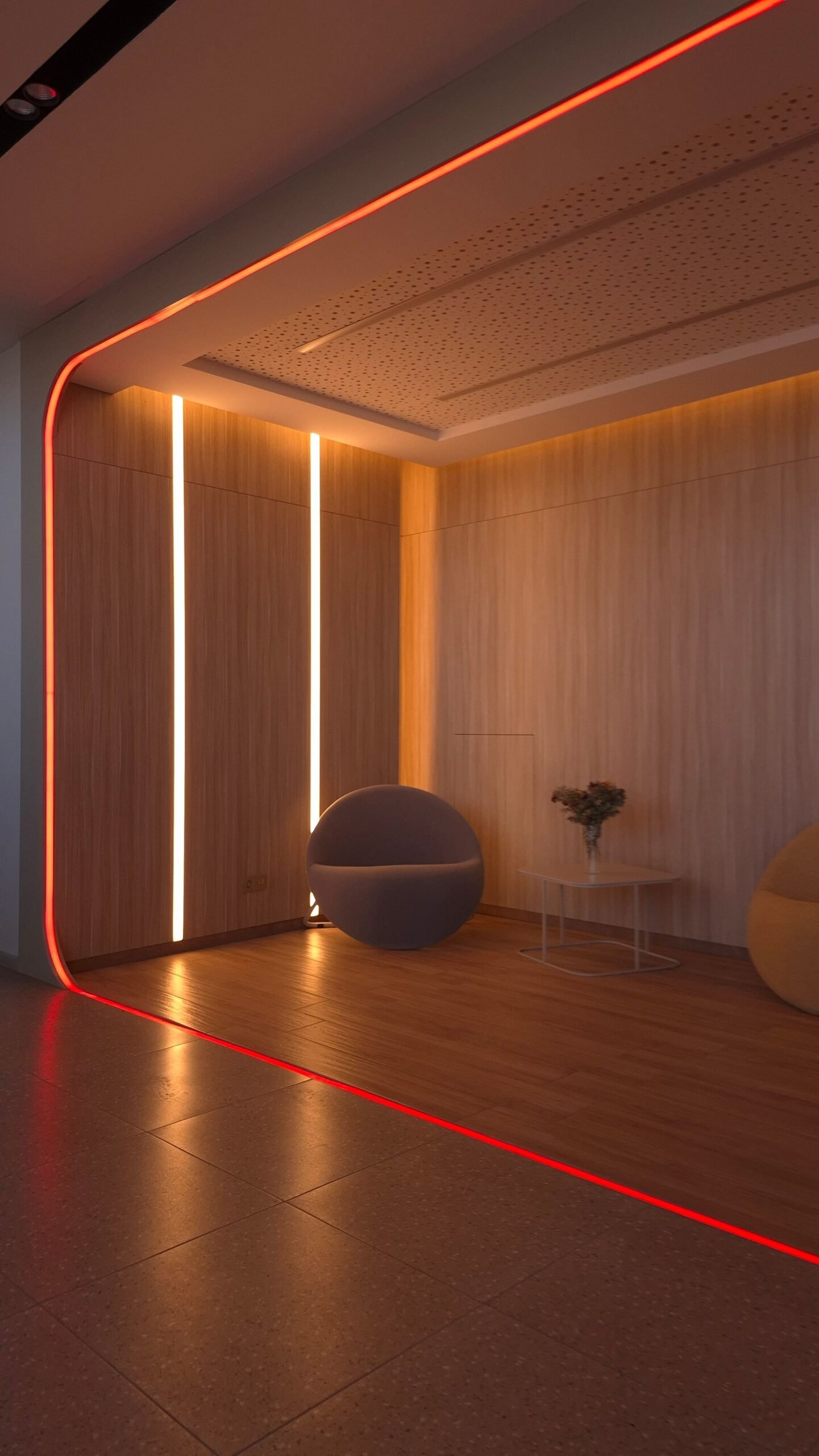 Warm cove lighting and accent lines in a lobby interior