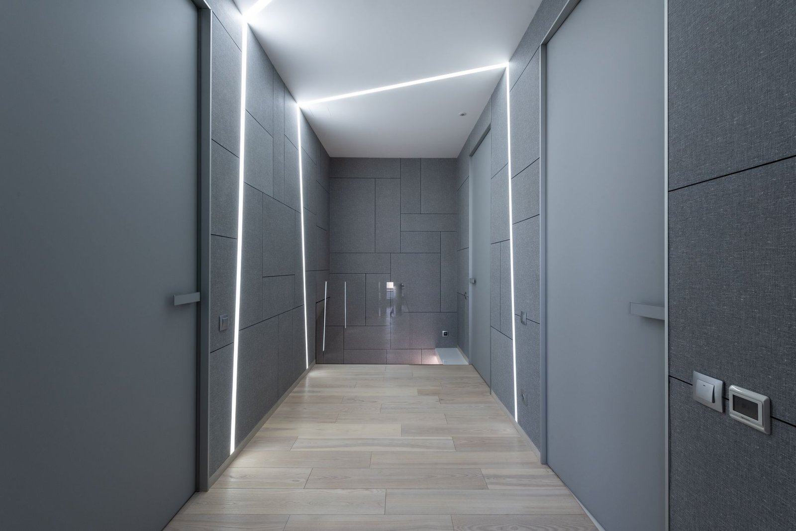 White LED cove and linear strips in a grey corridor