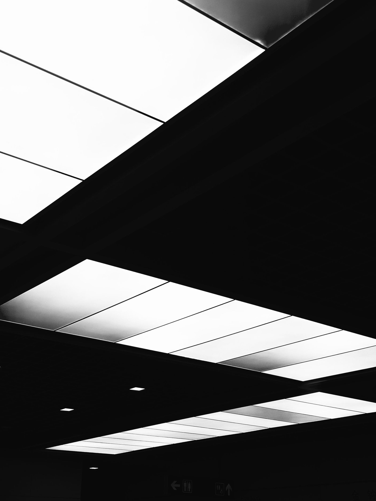 Backlit glass ceiling panels in a modern interior