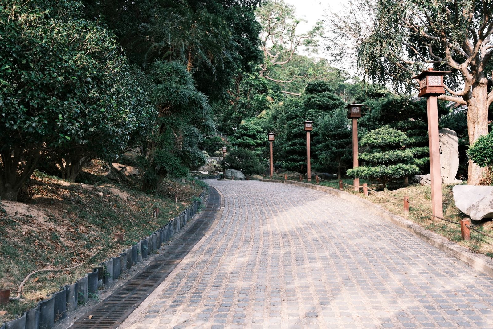Cobblestone drive with a line of low path lights