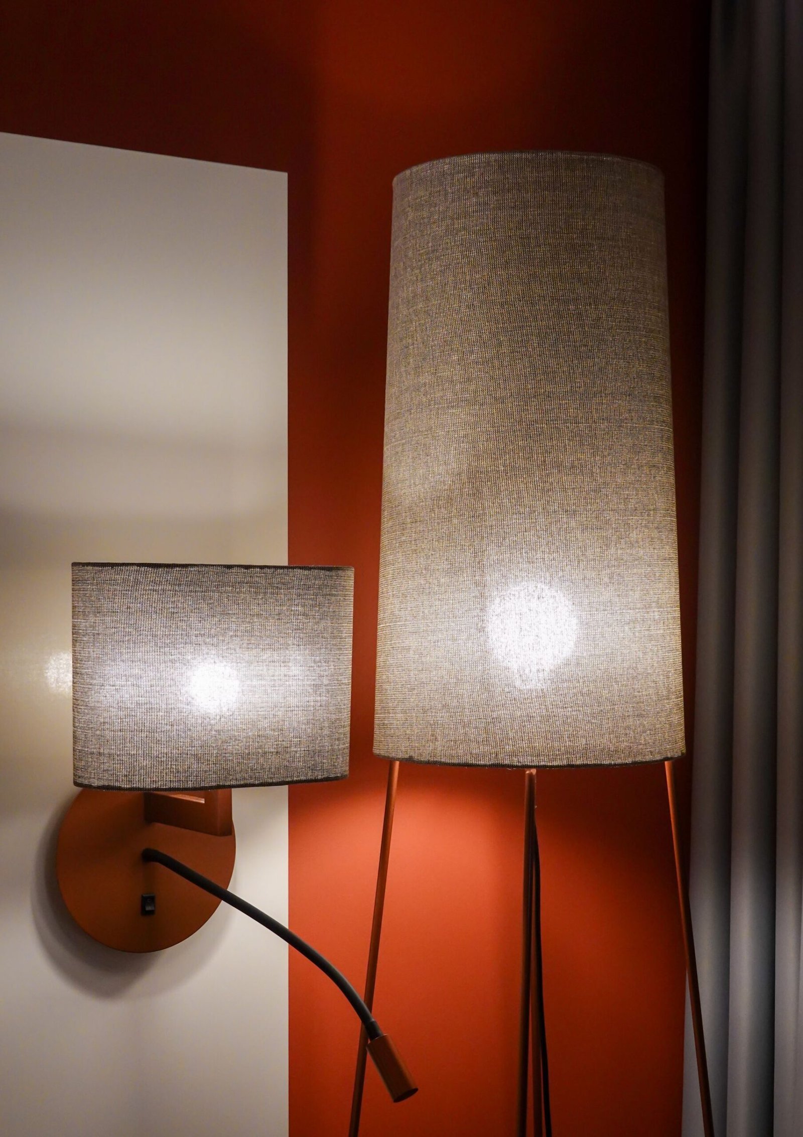 Two fabric drum lamps on an orange feature wall