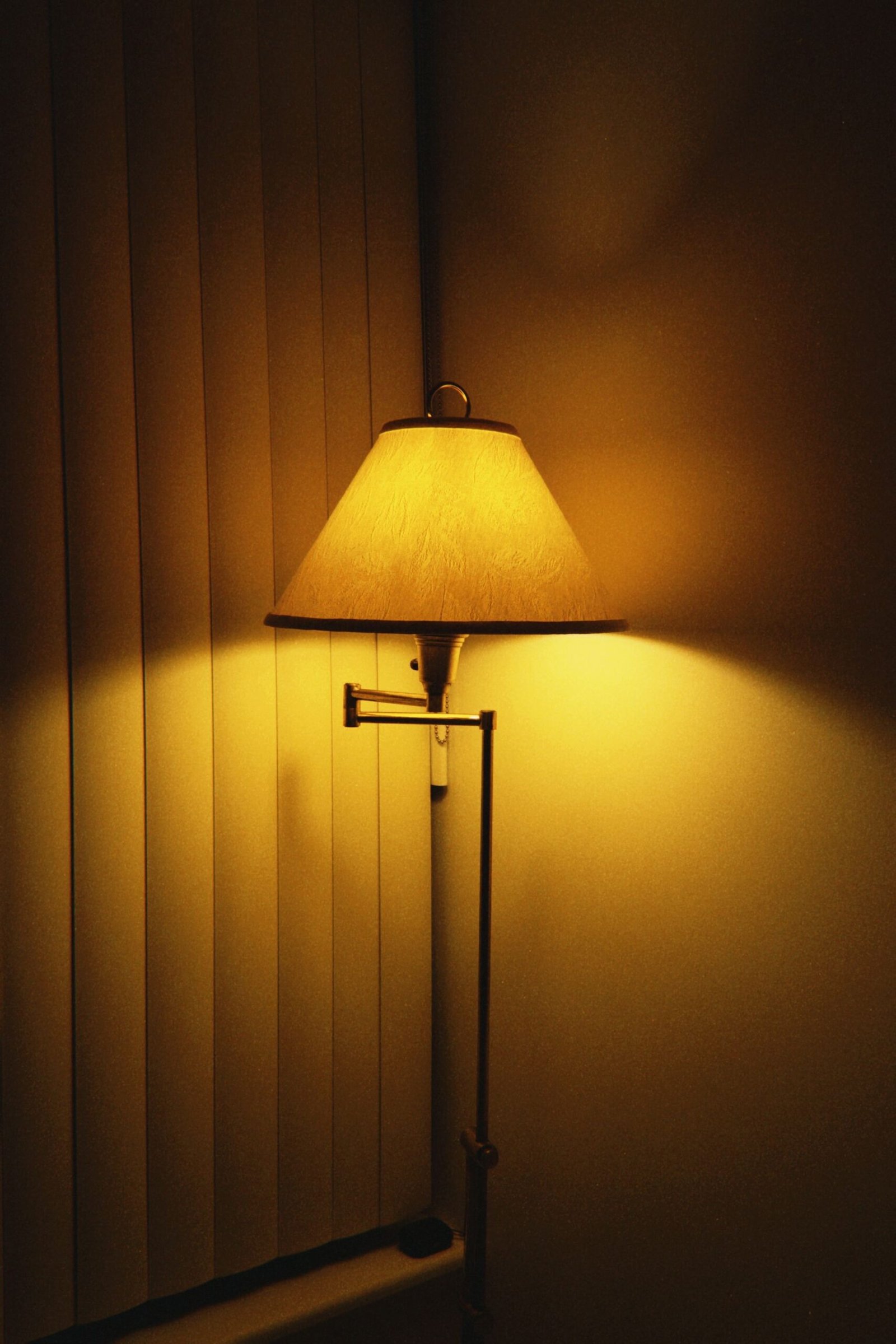 Warm lamp glowing against a dark timber wall