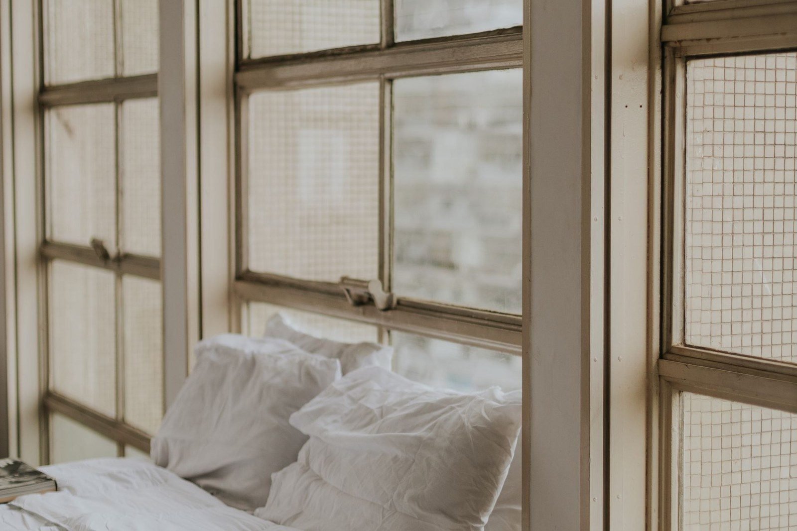 White linen bedding in a light-filled bedroom