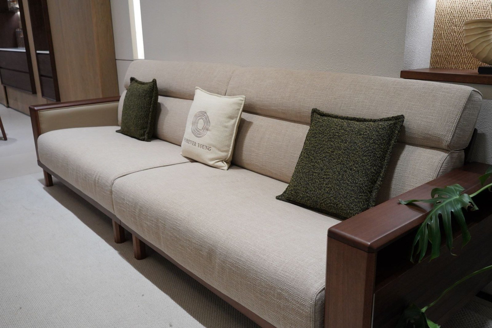 Olive and beige cushion set on a linen sofa