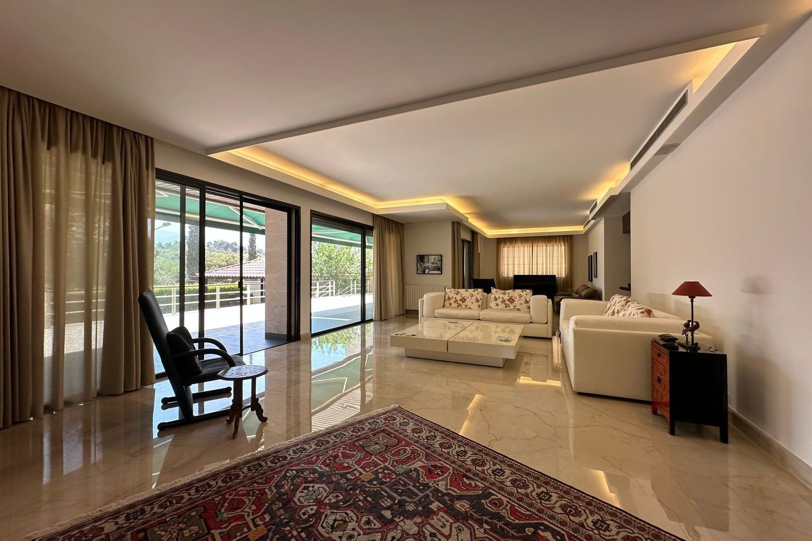 Styled villa living room — rug, curtains and cushion scheme