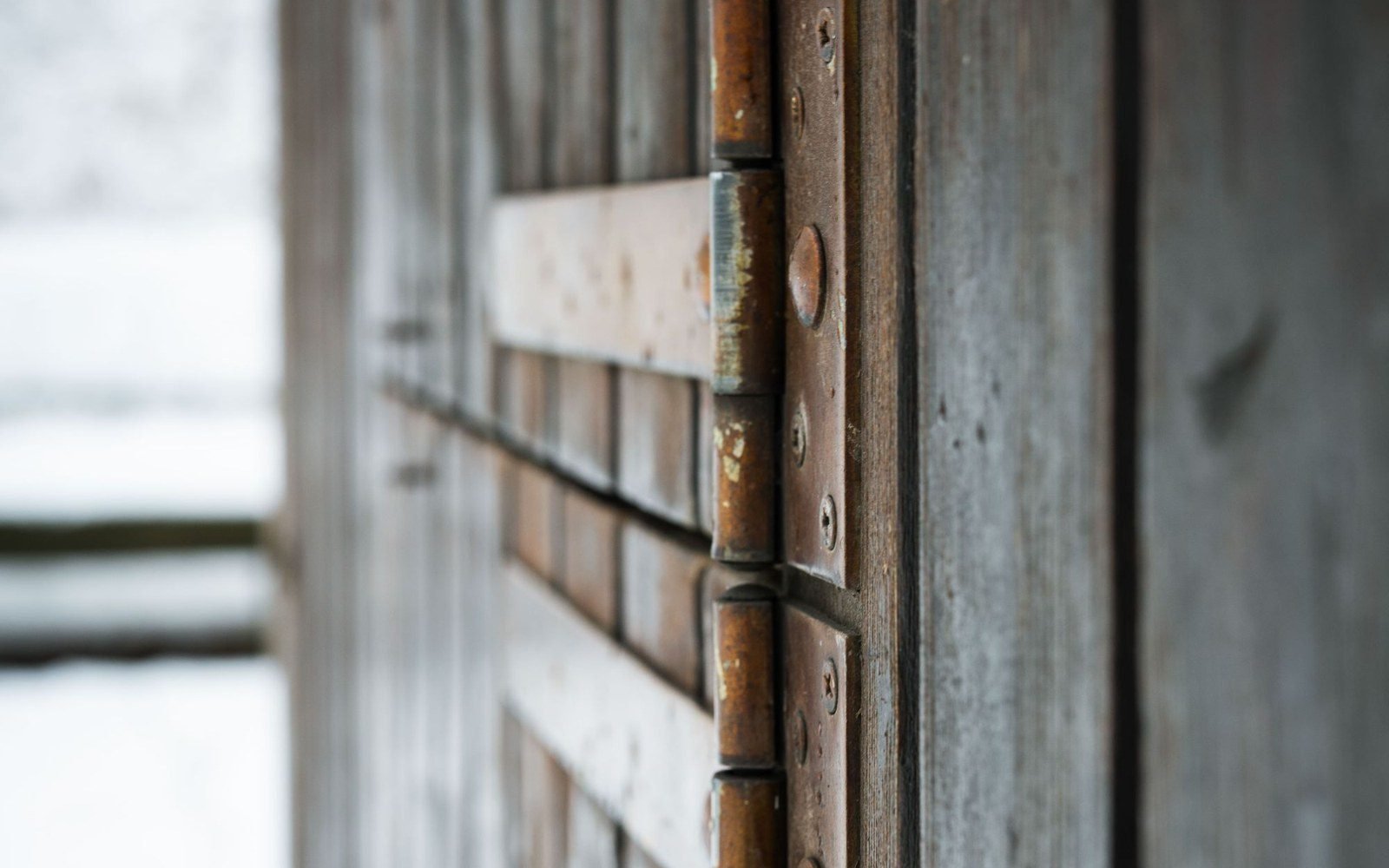 Rusted metal hinge on weathered wood, a hardware failure in its later stages (stock photo, Pexels 11891393)