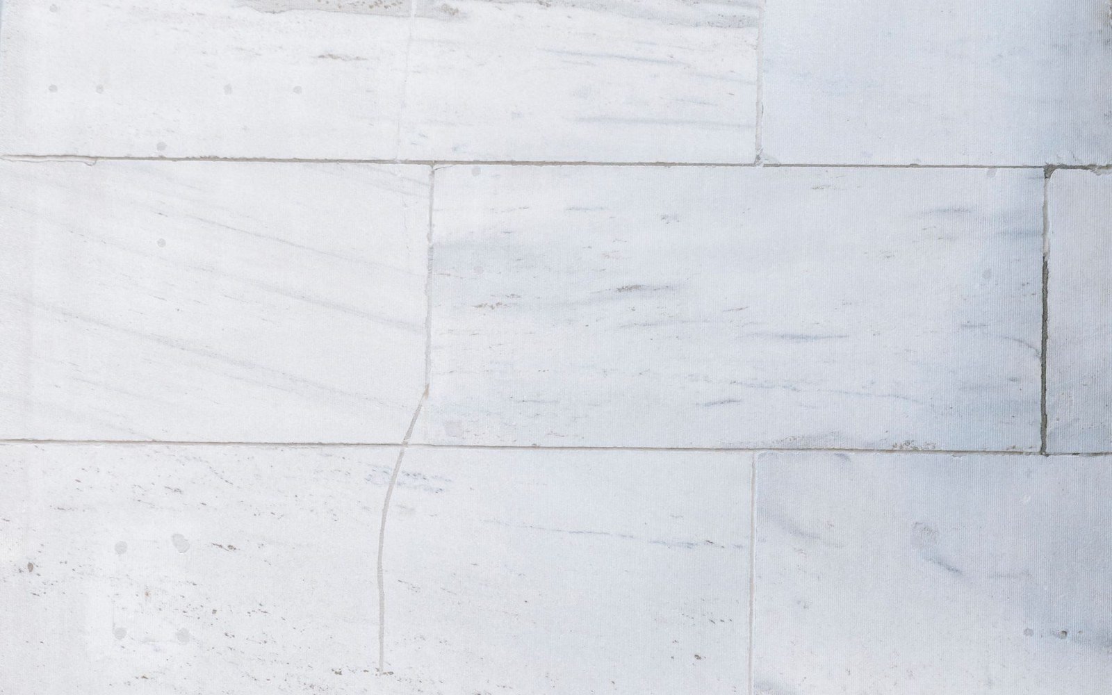 Closeup of white marble tiles with subtle natural veining (stock photo, Pexels 7078686)