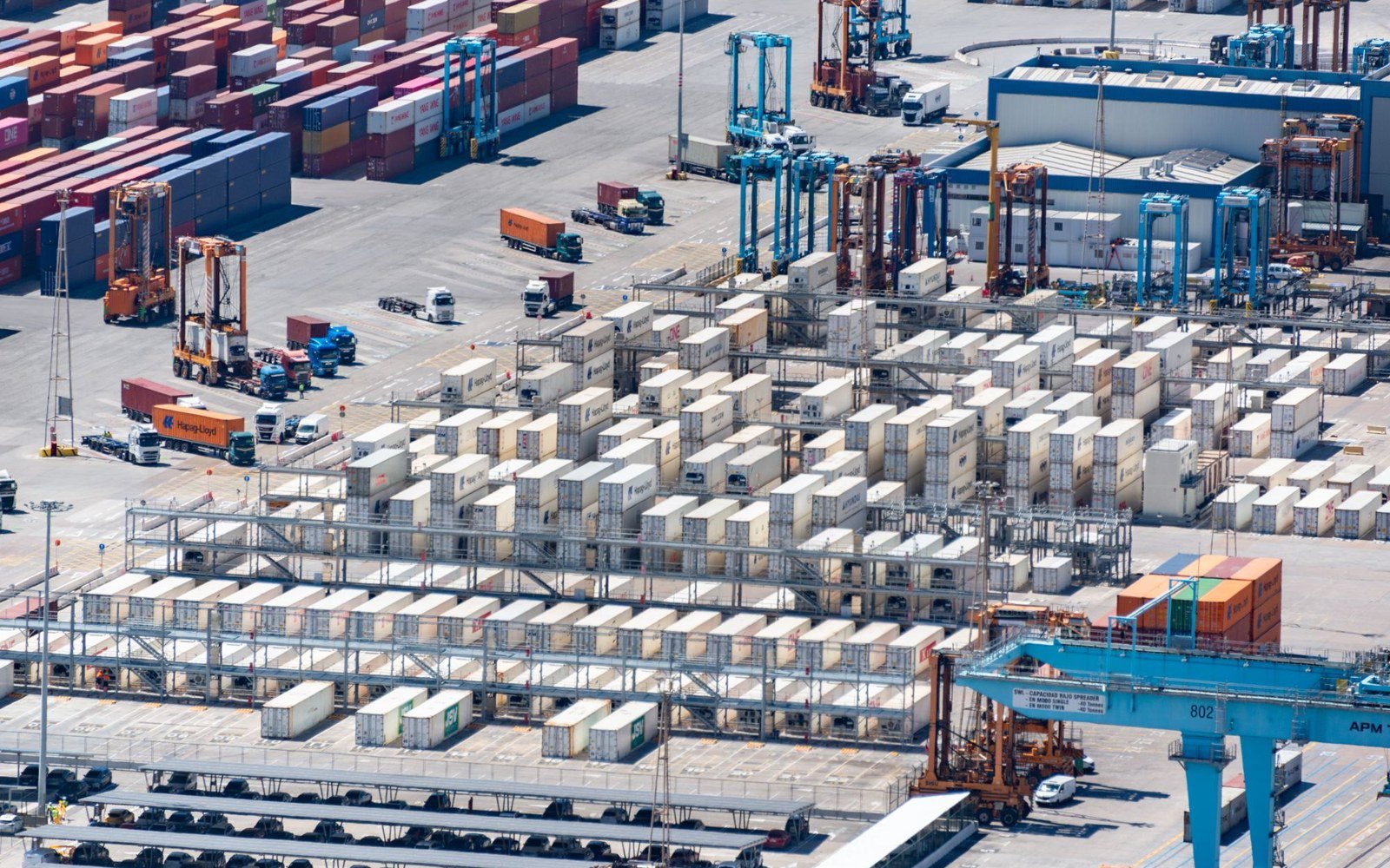 Aerial view of a container yard with shipping containers and terminal cranes