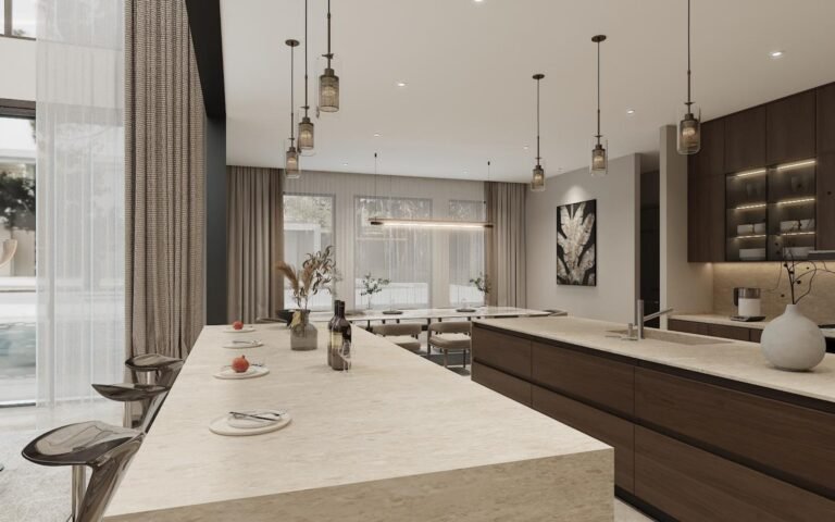 Kitchen island with four bar stools, stone waterfall ends and pendant lighting in a villa