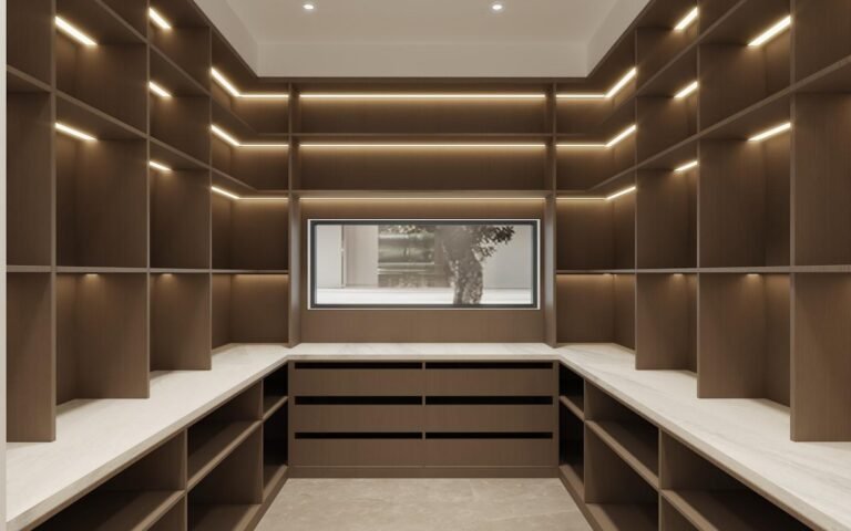 U-shaped walk-in pantry with floor-to-ceiling shelving, a central drawer bank and a stone counter in a villa