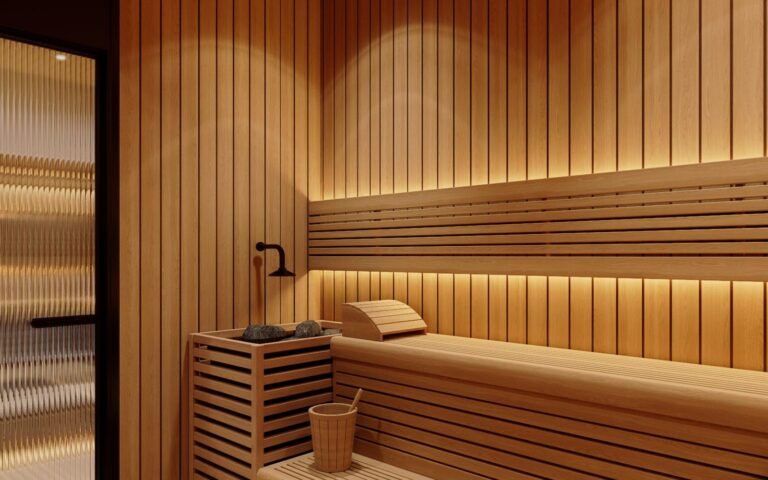 Sauna room with slat bench, stone heater and glass door in a villa wet room